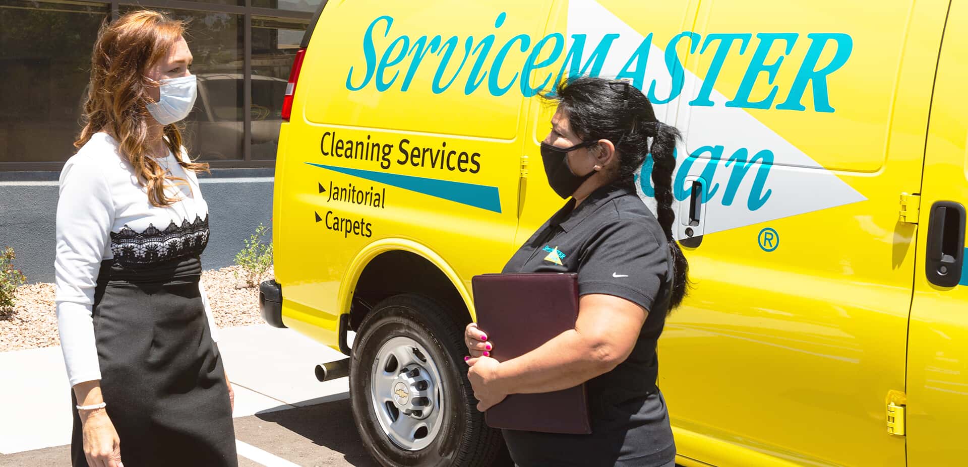 Two women in mask speaking