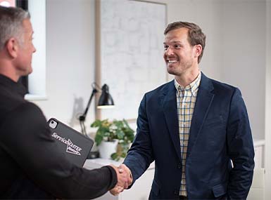 ServiceMaster Restore Technician shaking a client's hand